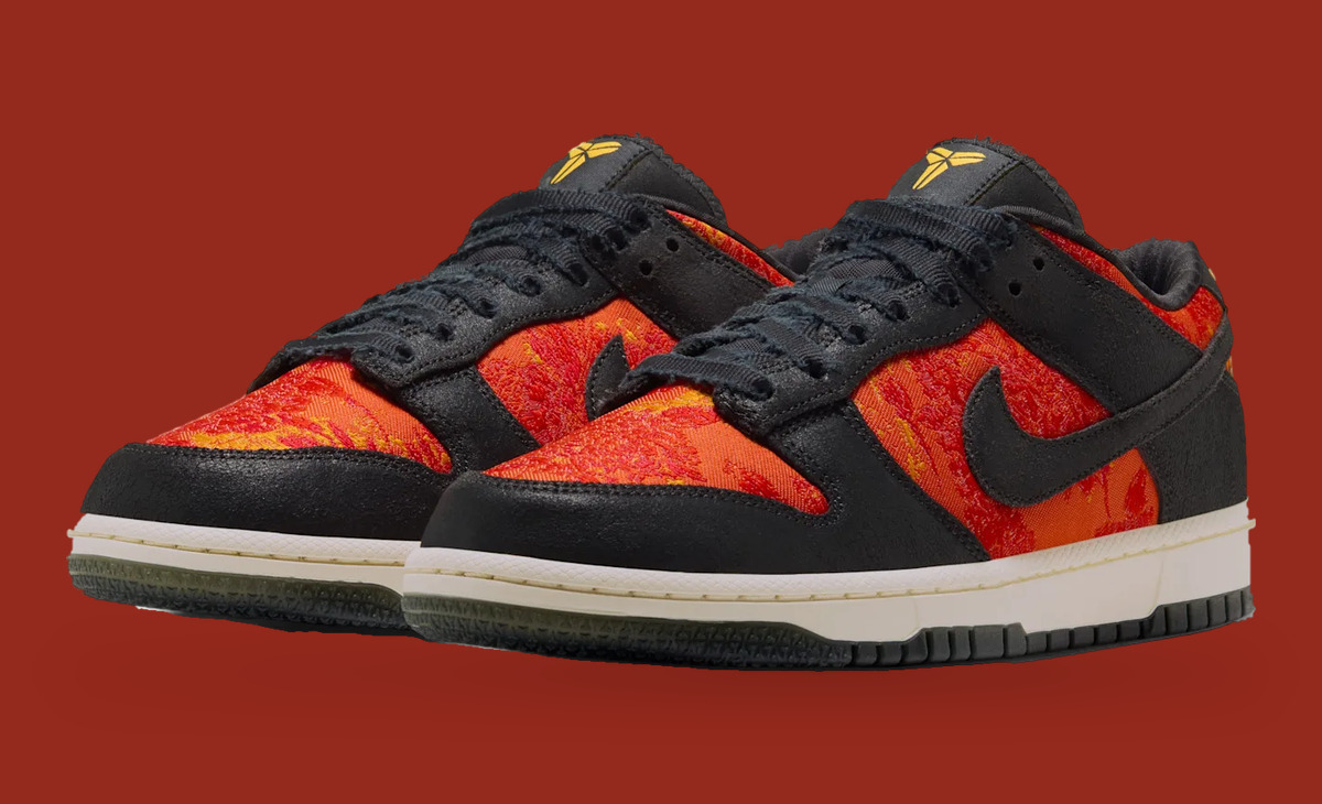 Pair, angled front view on red background, black frayed laces, gold tongue logos, red-orange woven panels, Mamba Eterno