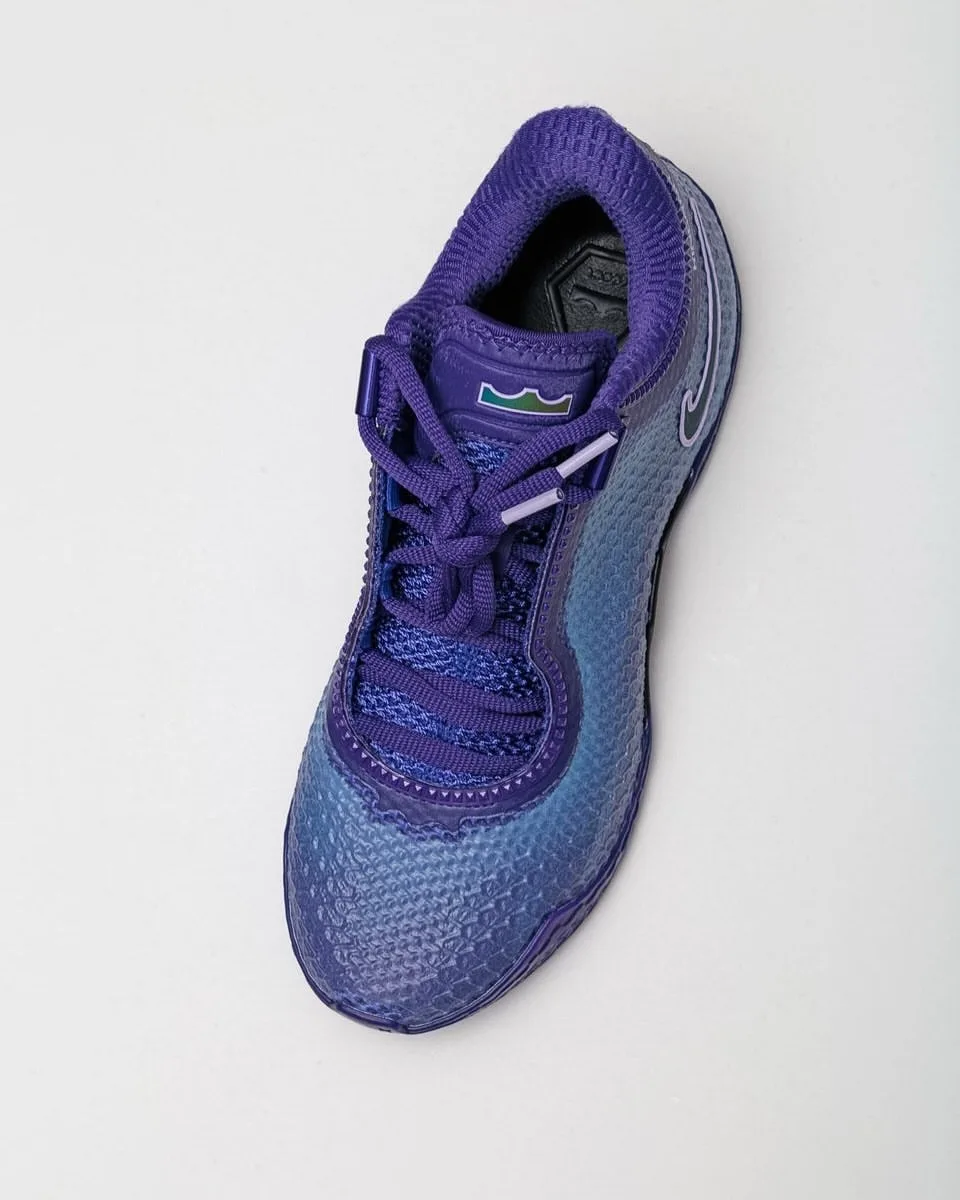 Top-down view of purple sneaker with purple laces, lavender lace tips and crown logo on tongue, Opening Night