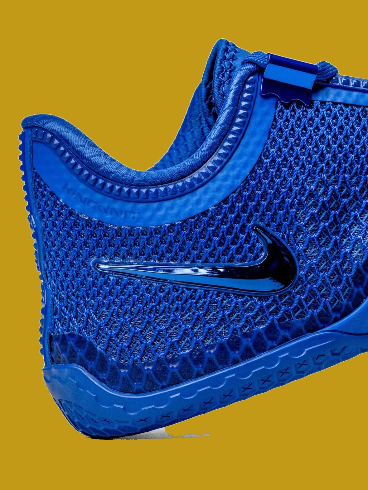 Detail of blue heel and lateral side, glossy swoosh, honeycomb mesh and ridged collar, Philly