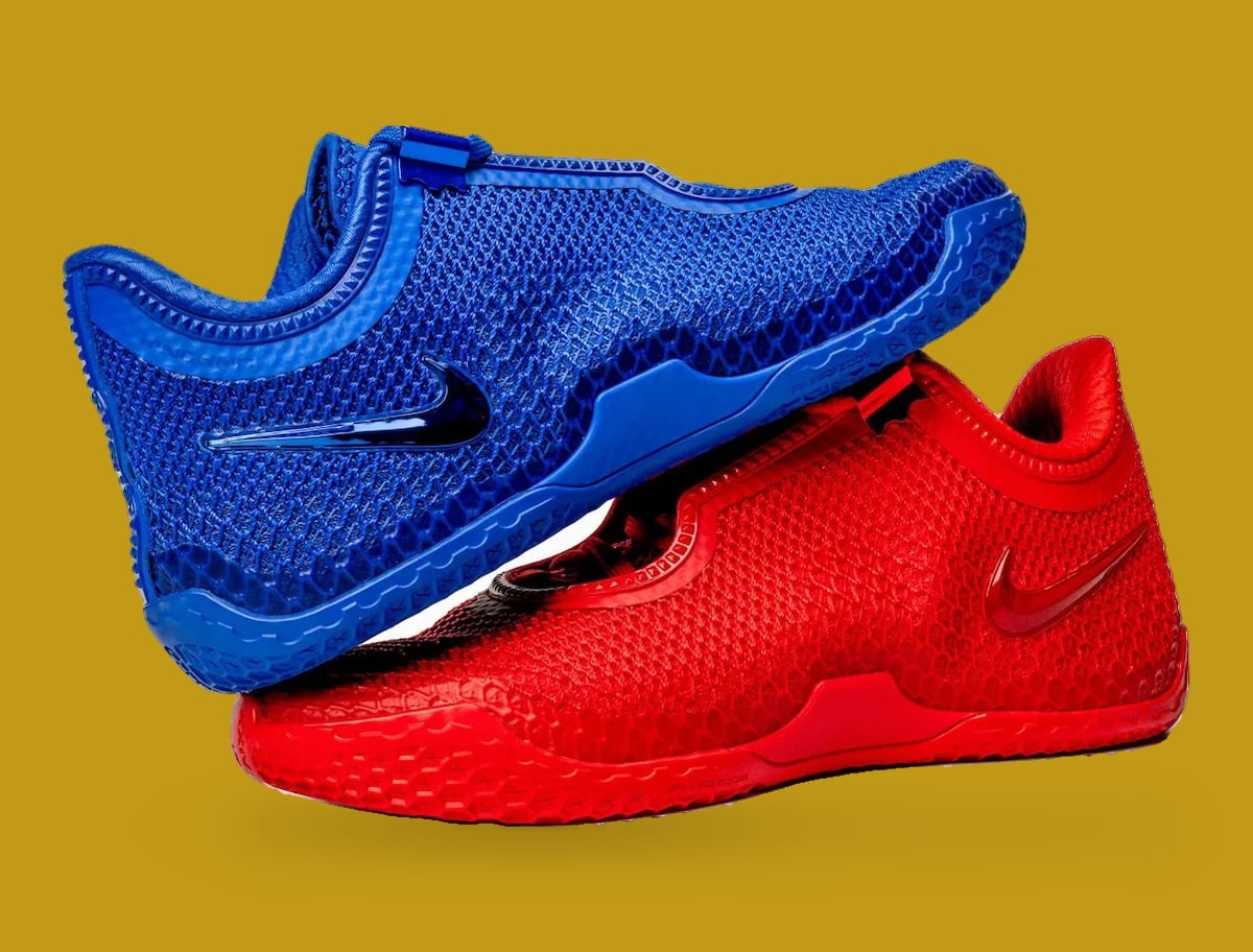 Lateral pair, blue shoe resting on red, glossy swooshes and textured mesh on gold, Philly