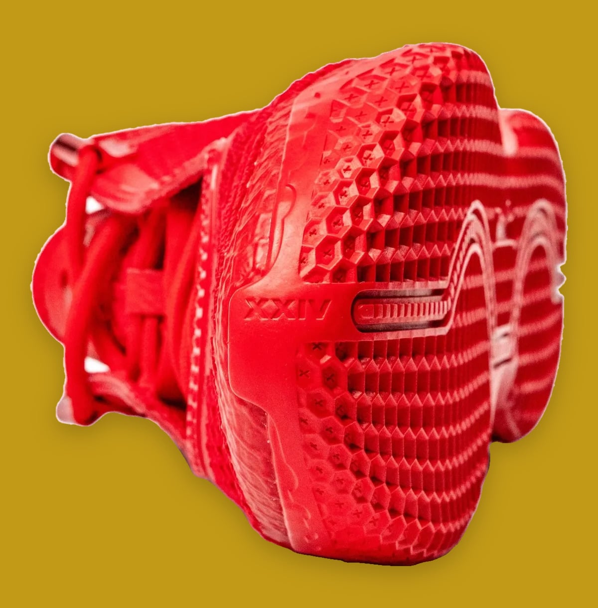 Outsole and toe view of red shoe, hexagon tread with X marks and XXIV text, Philly