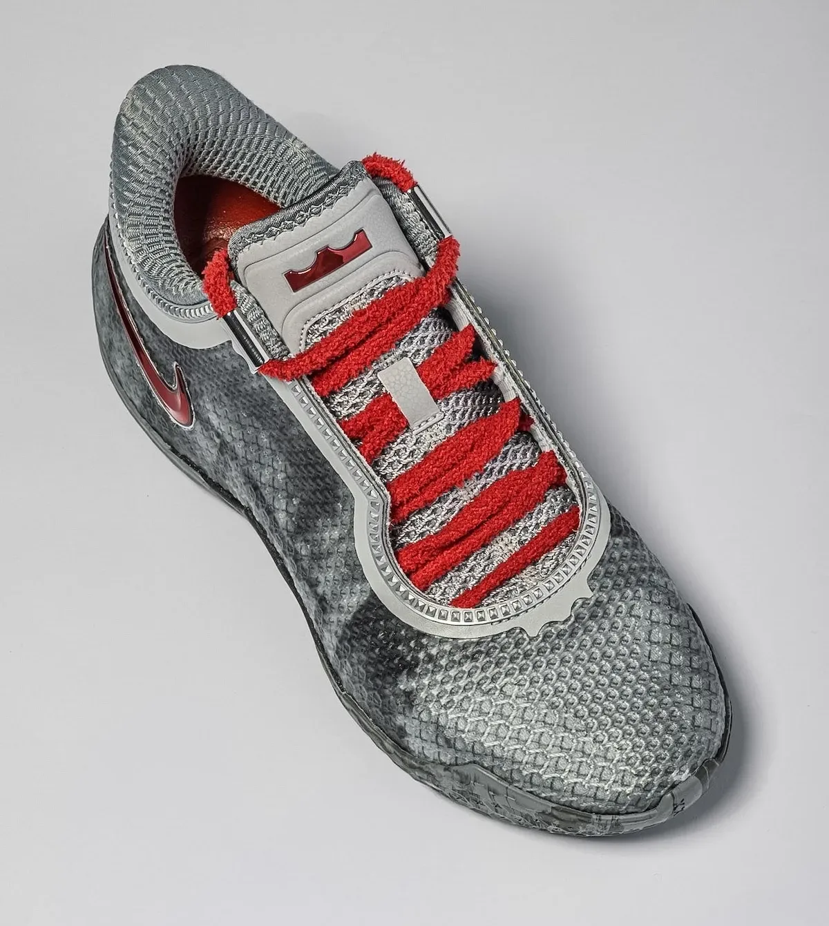 Top-down view, grey scaled upper, fuzzy red laces, red crown logo on tongue, red chrome swoosh, Storm Drain