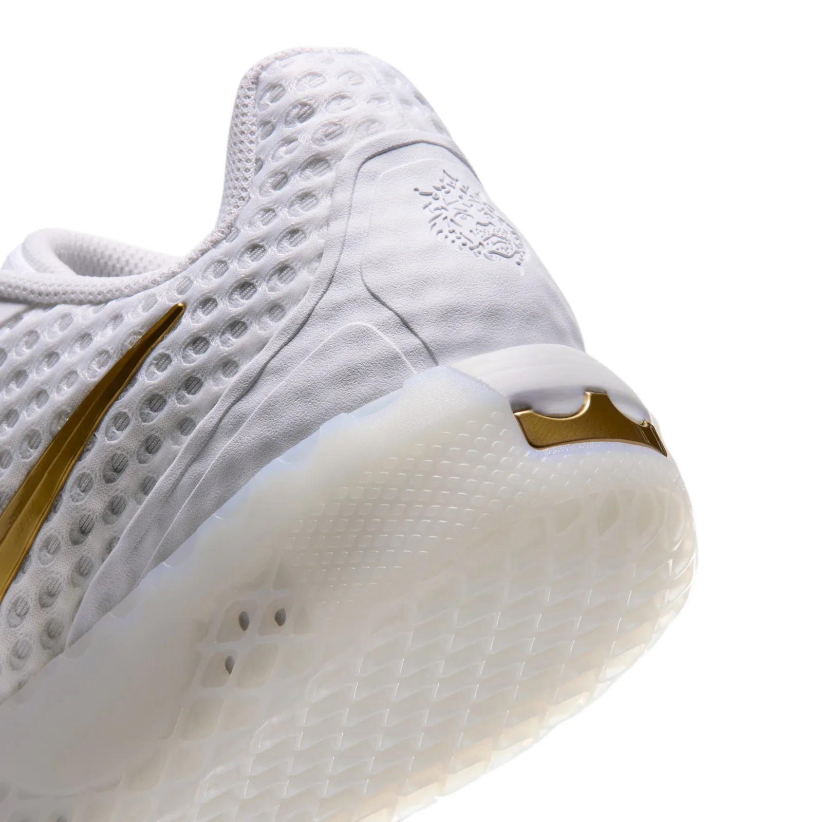 Heel detail with an embossed lion emblem and gold crown above the milky sole, White