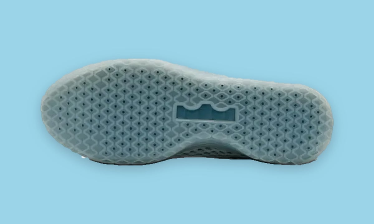 Outsole view, translucent pale blue sole with honeycomb tread pattern and blue logo block, Fiberglass