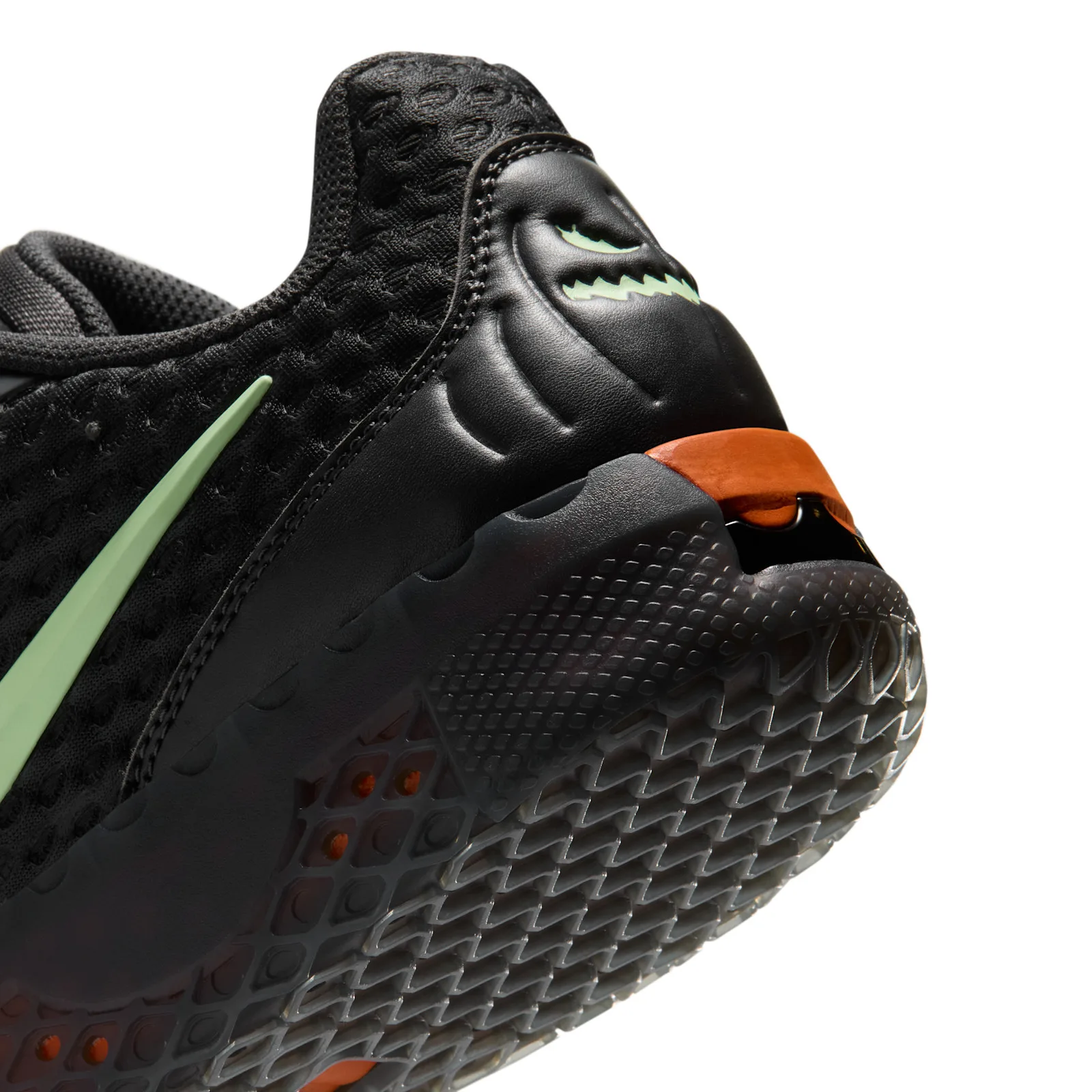 Heel detail with a pale green jack-o’-lantern face and orange sole accent, Halloween
