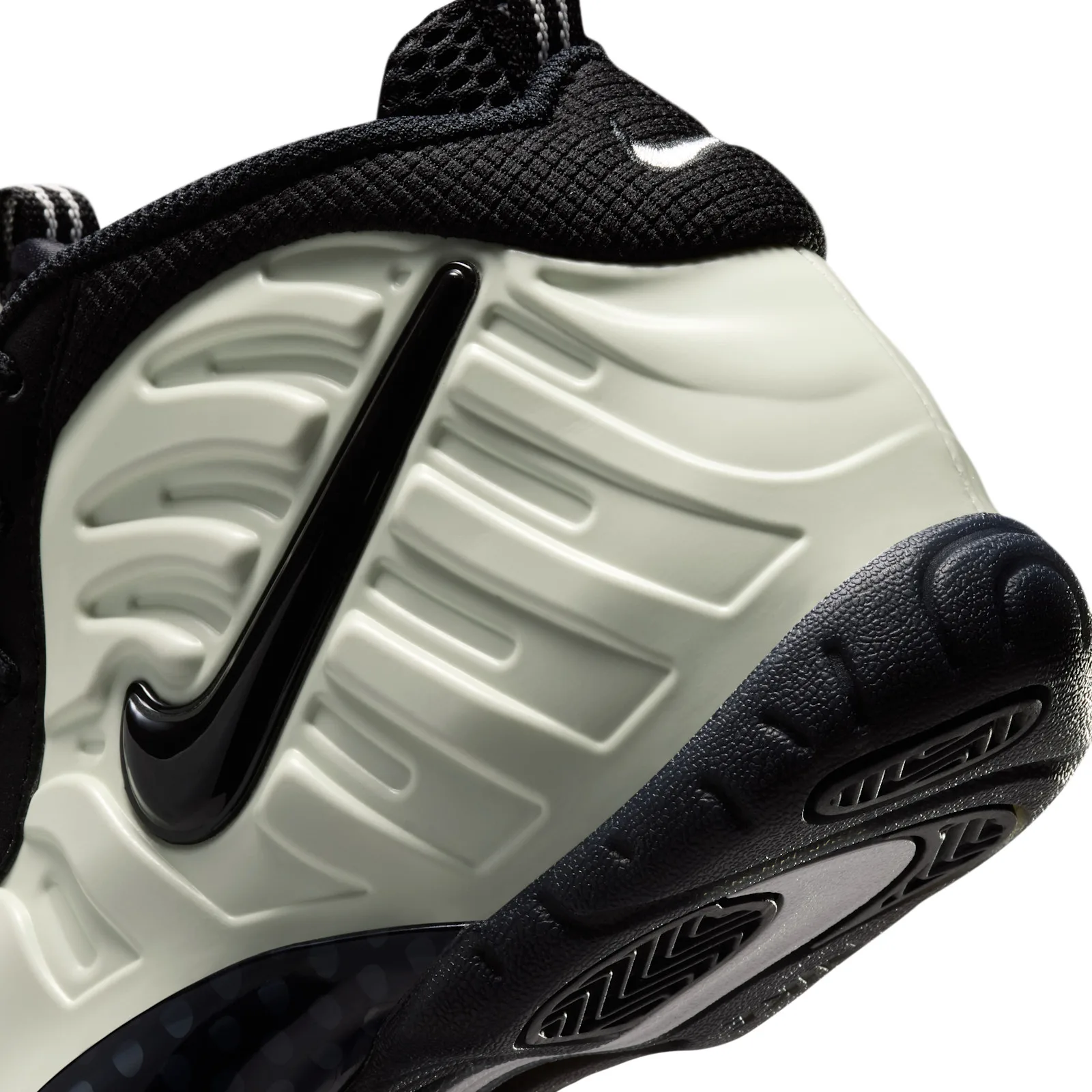 Detail of heel, ridged pale shell with glossy black swoosh and textured black sole, Glow In The Dark