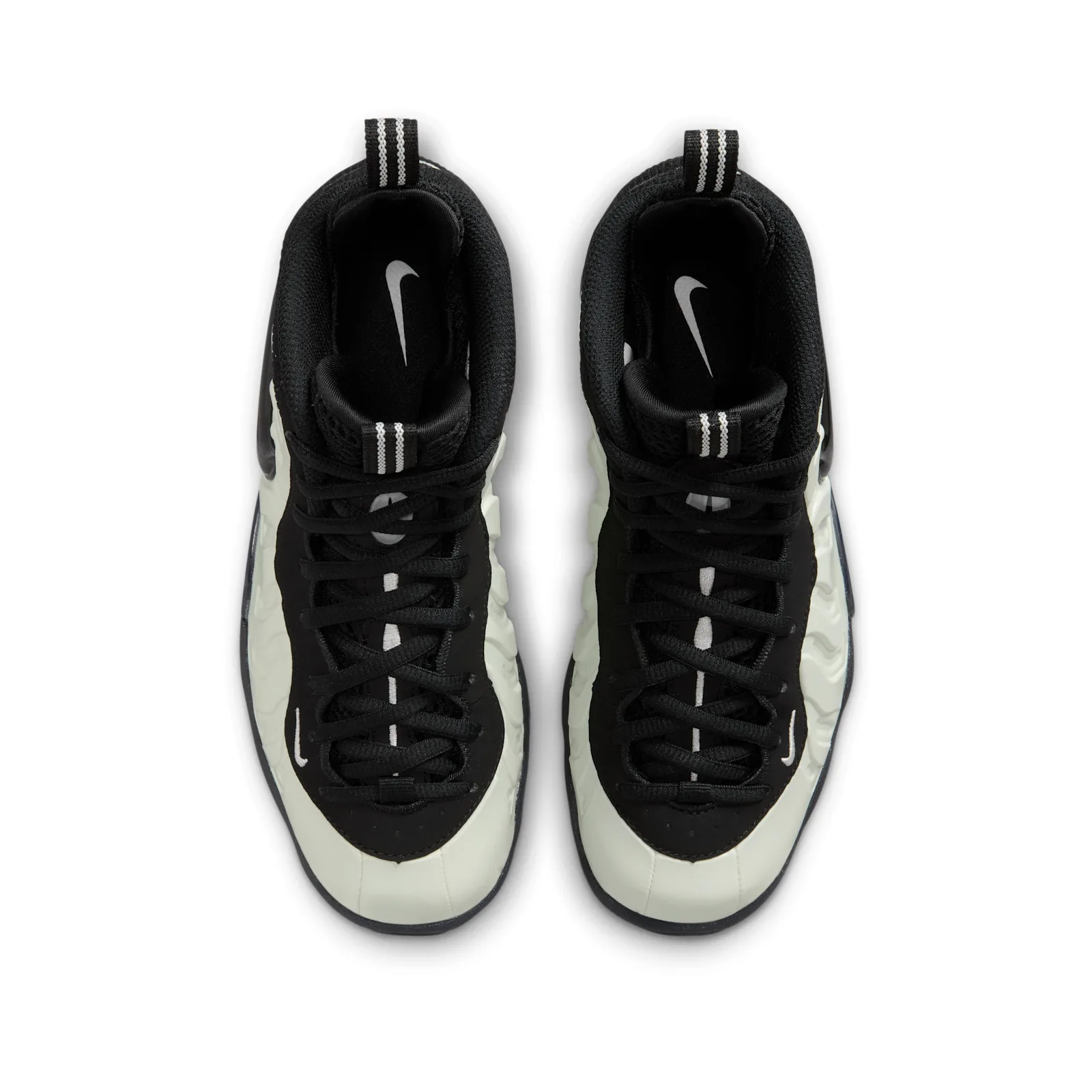 Top-down view of pair, black laces and collars, pale shell edges, silver swoosh insoles, Glow In The Dark