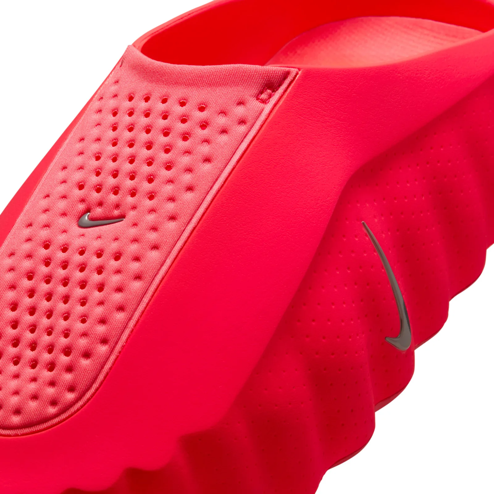 close-up of ribbed heel panel, perforated upper and metallic swoosh, Solar Red