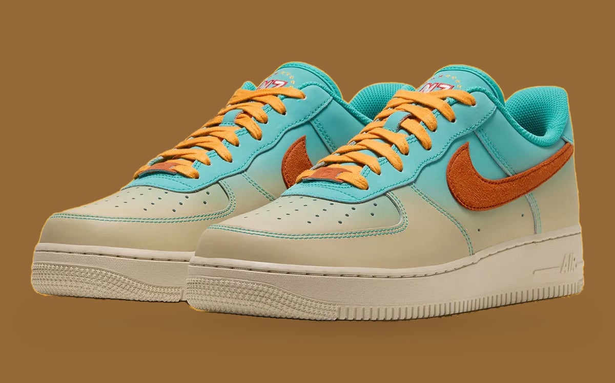 Pair in three-quarter view, teal-to-cream fade, orange fuzzy swooshes, yellow laces, N7 on tongue, Holiday 2026 Collection