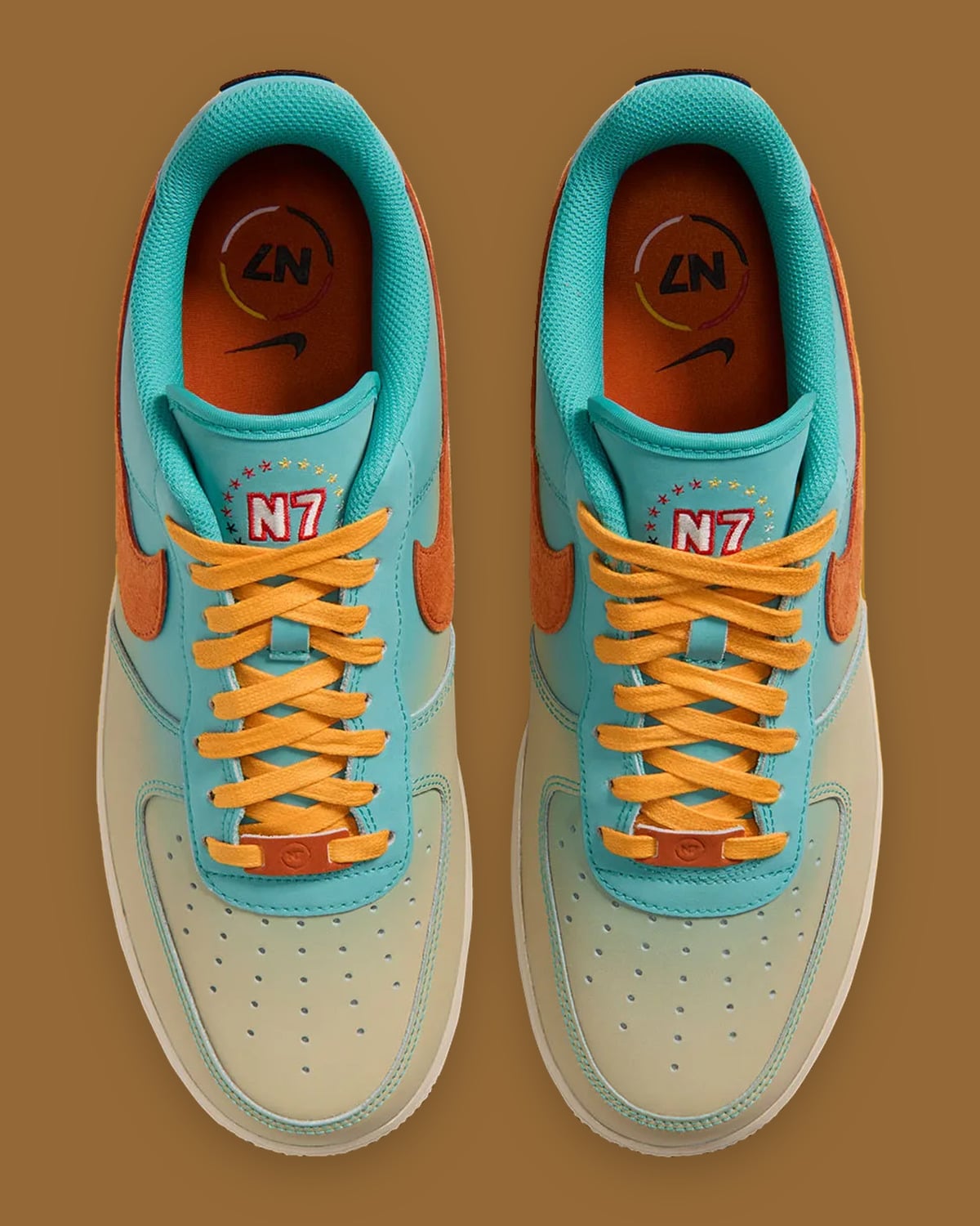 Top-down view of pair, yellow laces, N7 tongue embroidery, orange insoles with N7 circle and Nike logo, Holiday 2026