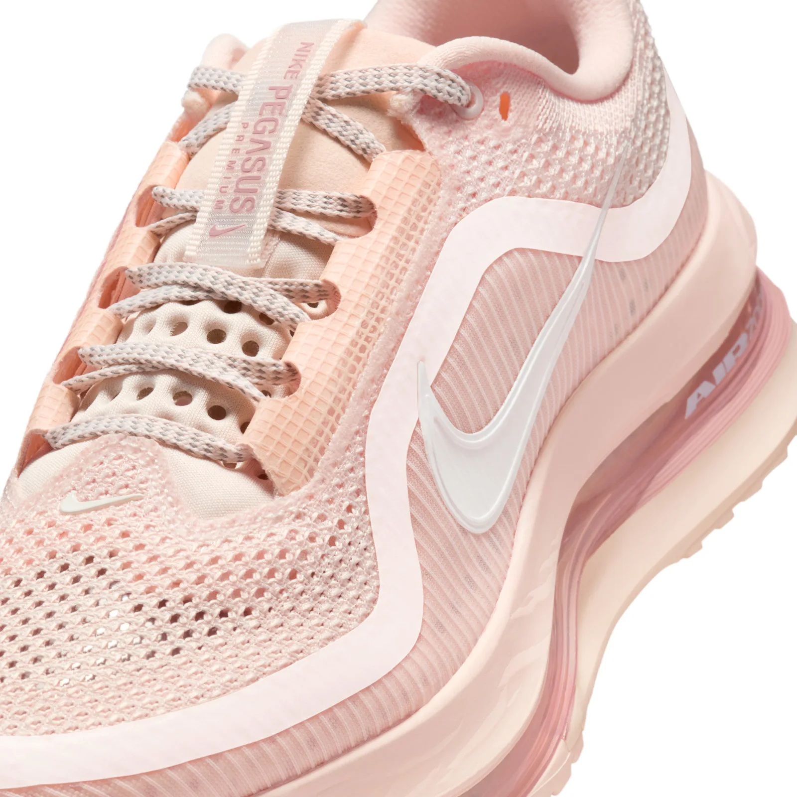Detail of laces, tongue tag and white swoosh on pale pink mesh, "Air" text on the midsole, Guava Ice