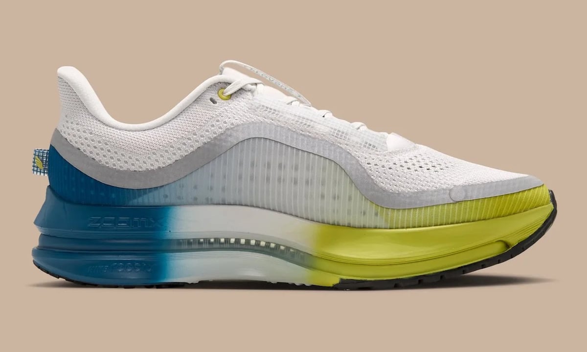 Medial view, white mesh upper, blue heel and yellow-green forefoot midsole, black outsole, The Perfect Texture For Running