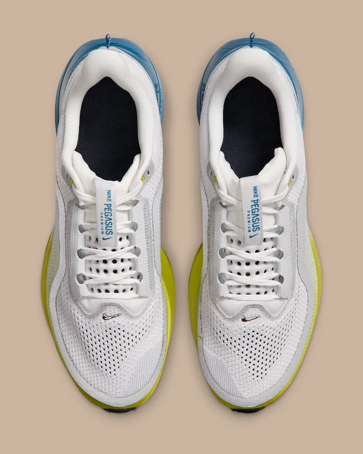 Top-down pair, white mesh and laces, blue tongue label text, yellow-green midsole edges, The Perfect Texture For Running