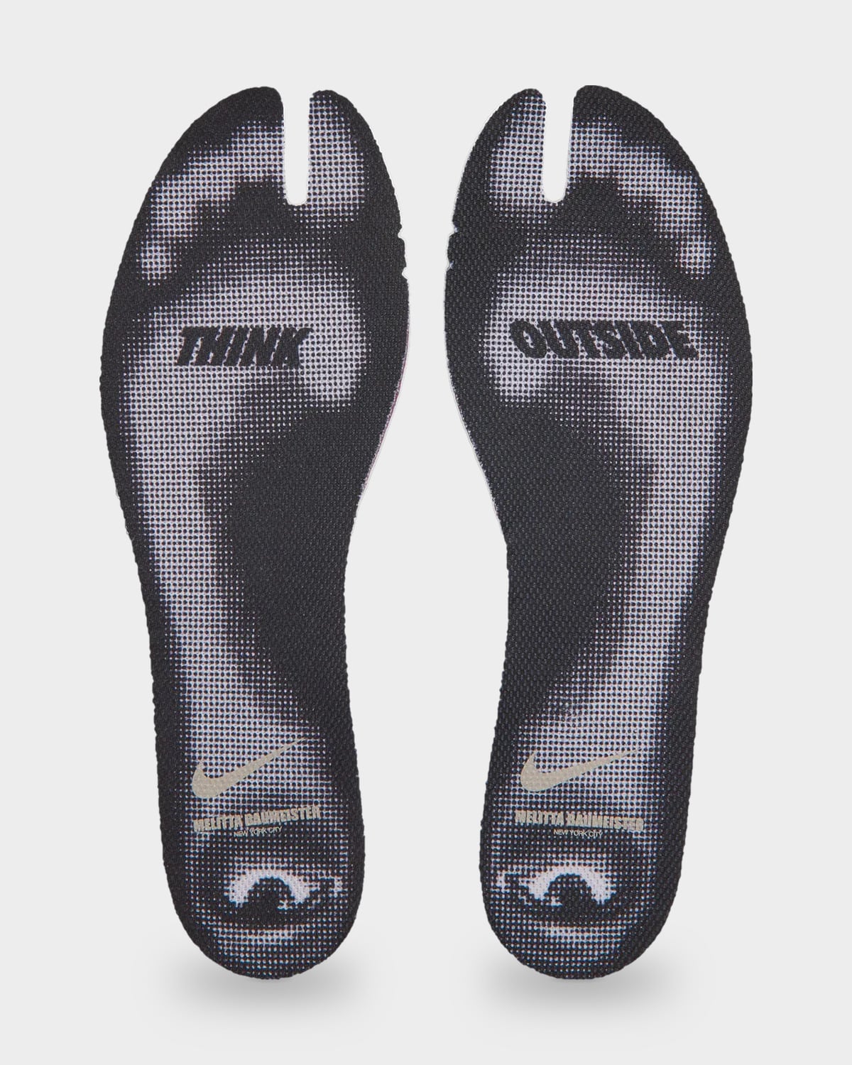 Insole pair detail with black-and-white faces and THINK OUTSIDE lettering, Nike Rift Rocker