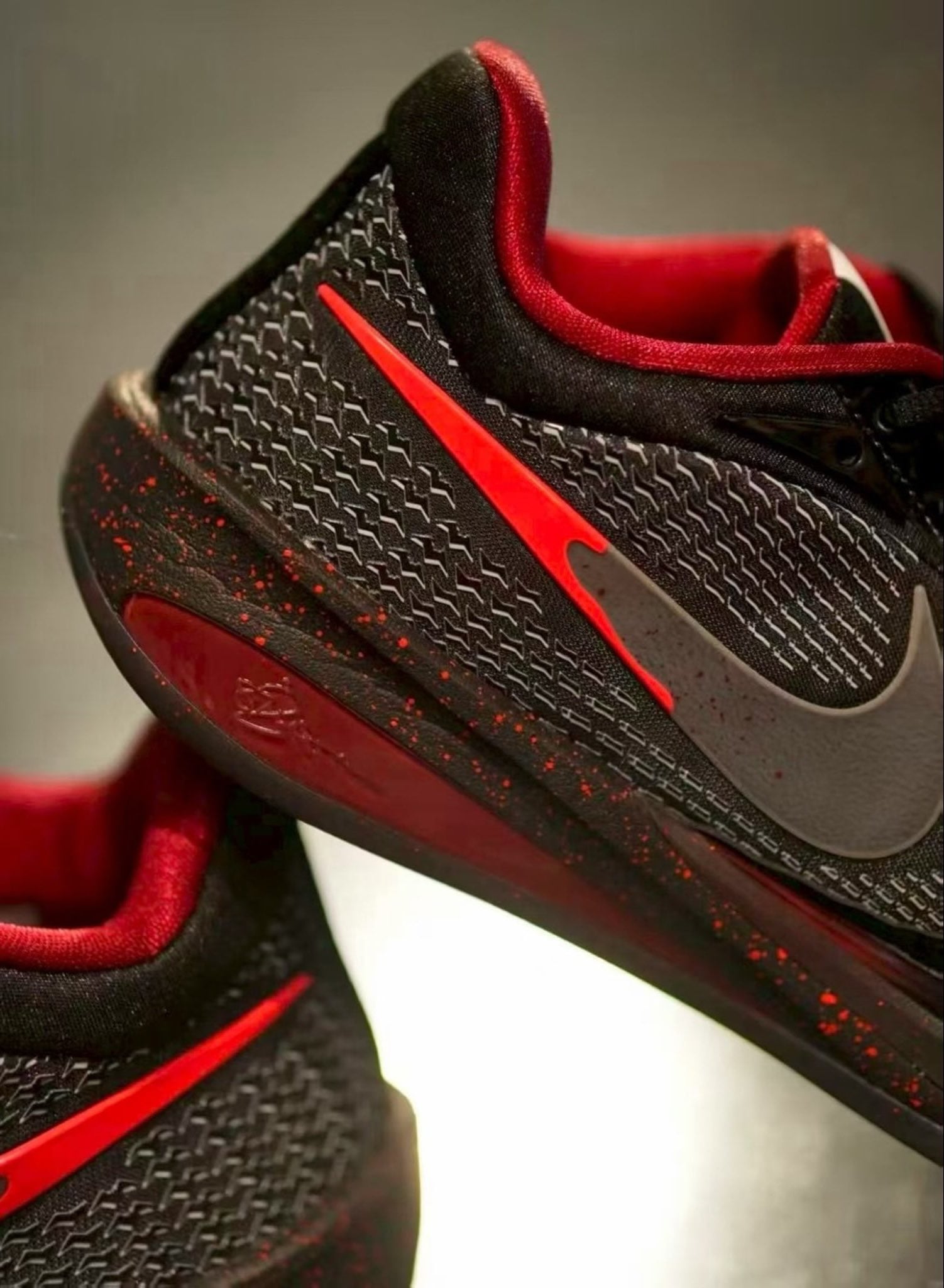 Close-up of the heel and midfoot, red swoosh tail, red speckles on black midsole, red collar, Halloween