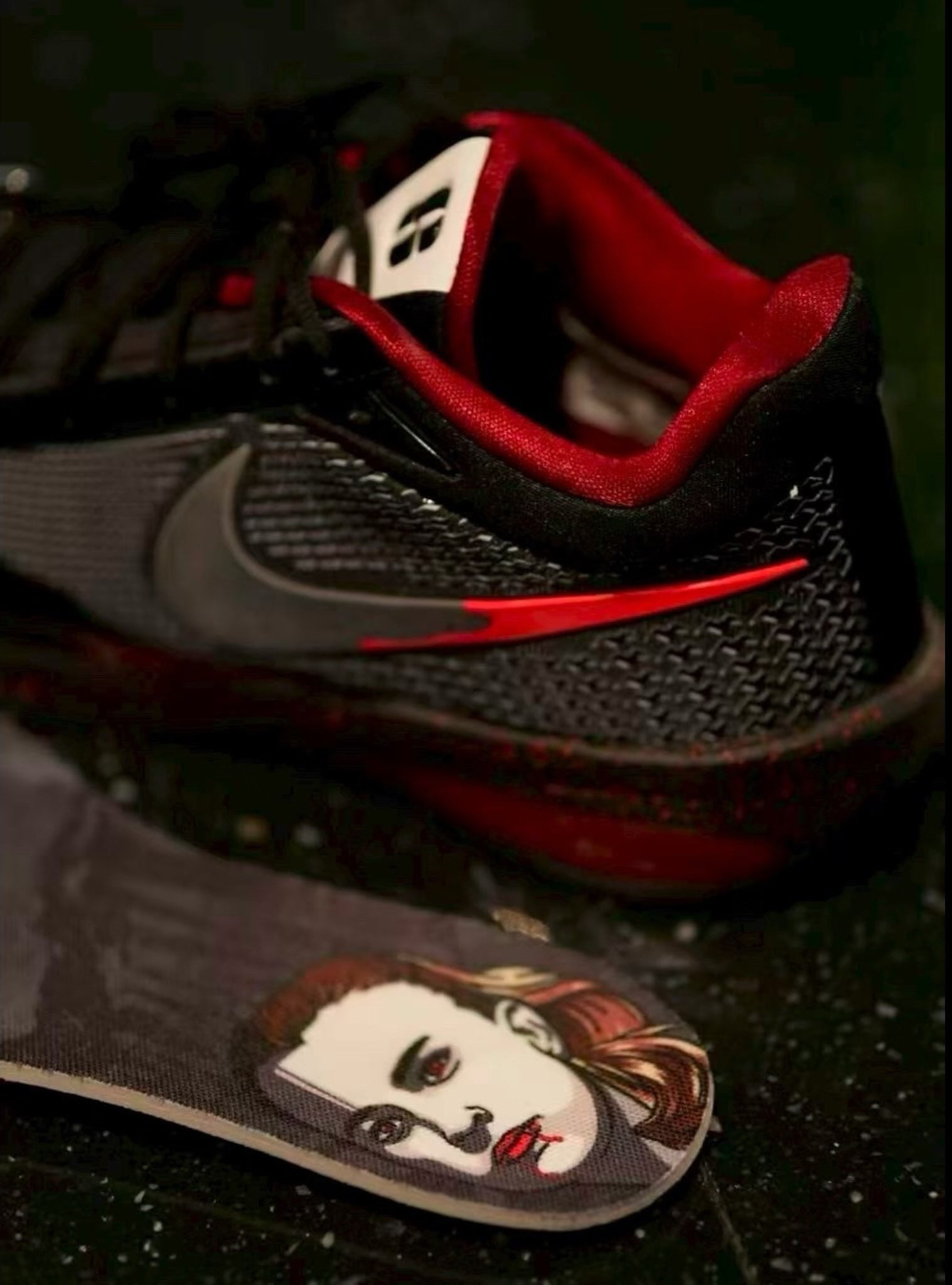 Rear angled view with a removable insole in front showing a drawn face illustration, red lining, Halloween