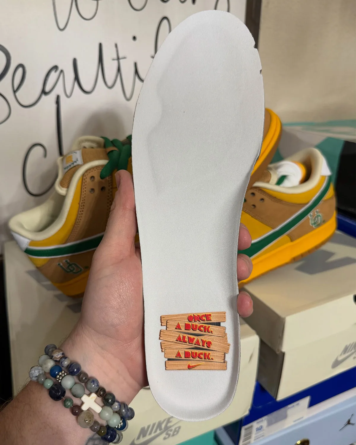 In-hand white insole printed with Once a duck, always a duck wood-plank graphic, Shout