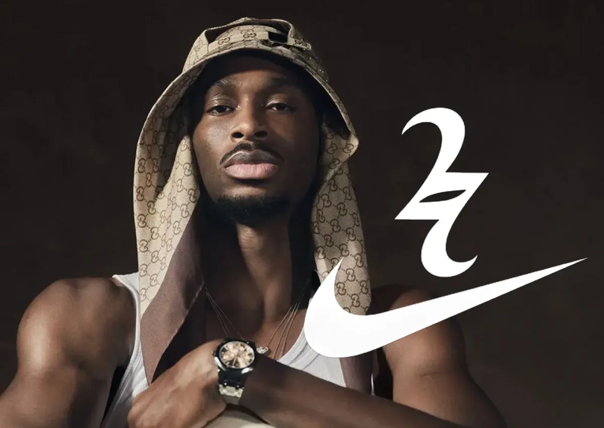 Man in monogram bucket hat and watch, white Nike swoosh and stylised 2 logo on dark brown background, Nike SHAI 002
