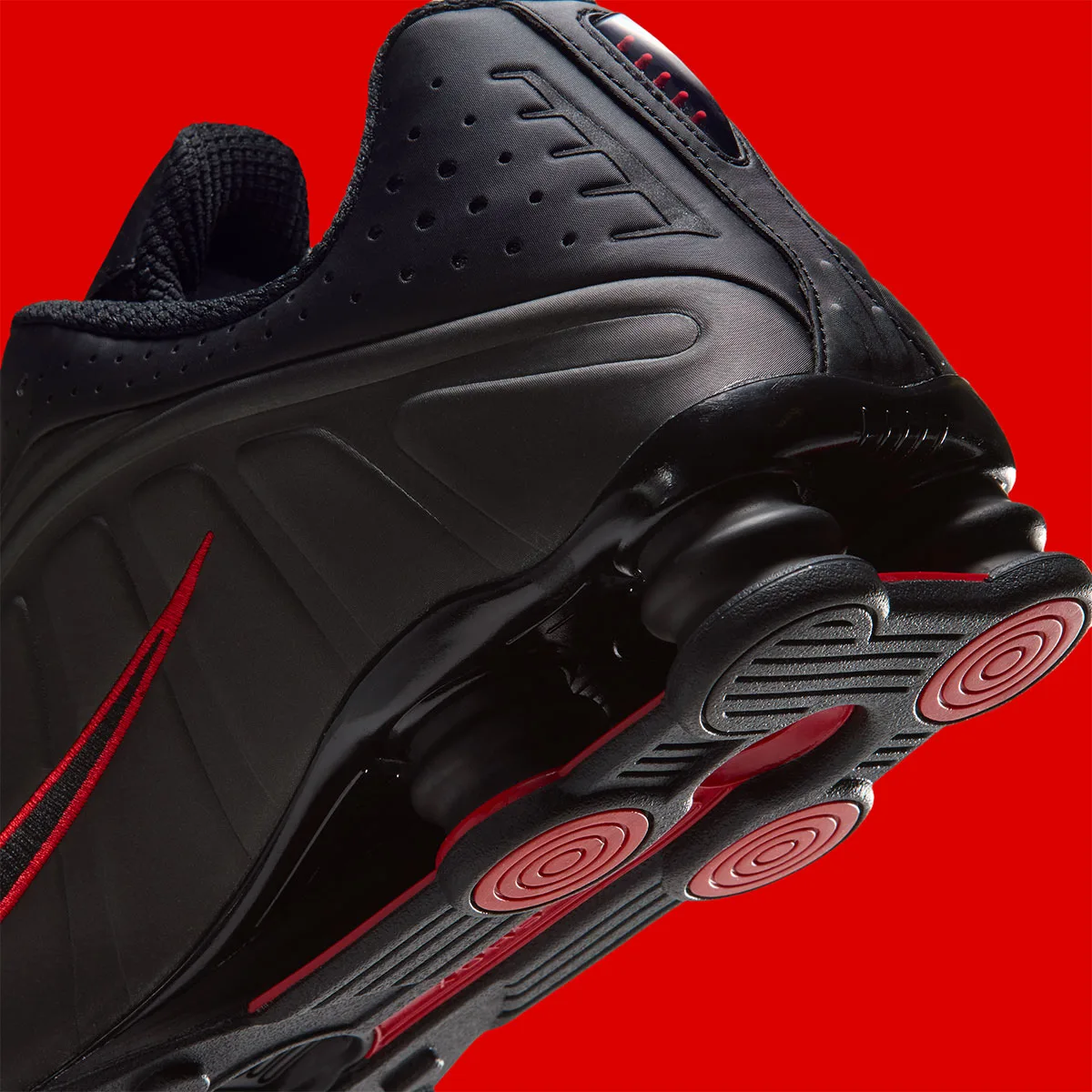 Heel detail with black cushioning columns and red circular outsole pads, Black/Challenge Red