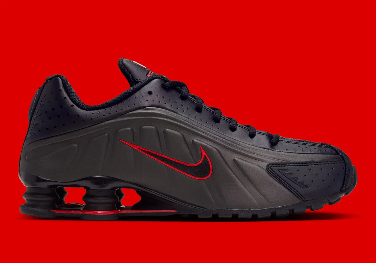 Medial view of black sculpted upper with red-outlined Swoosh and heel columns, Black/Challenge Red