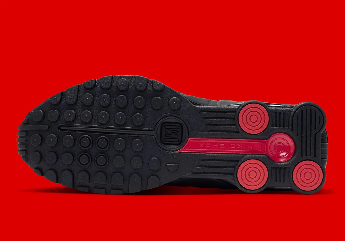 Outsole view with black circular tread and red circular heel pads, Black/Challenge Red