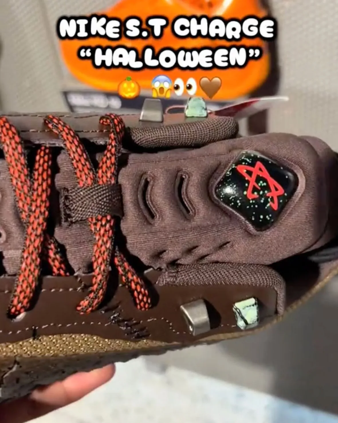 In-hand top detail of laces and tongue star badge with caption text overlay, Halloween