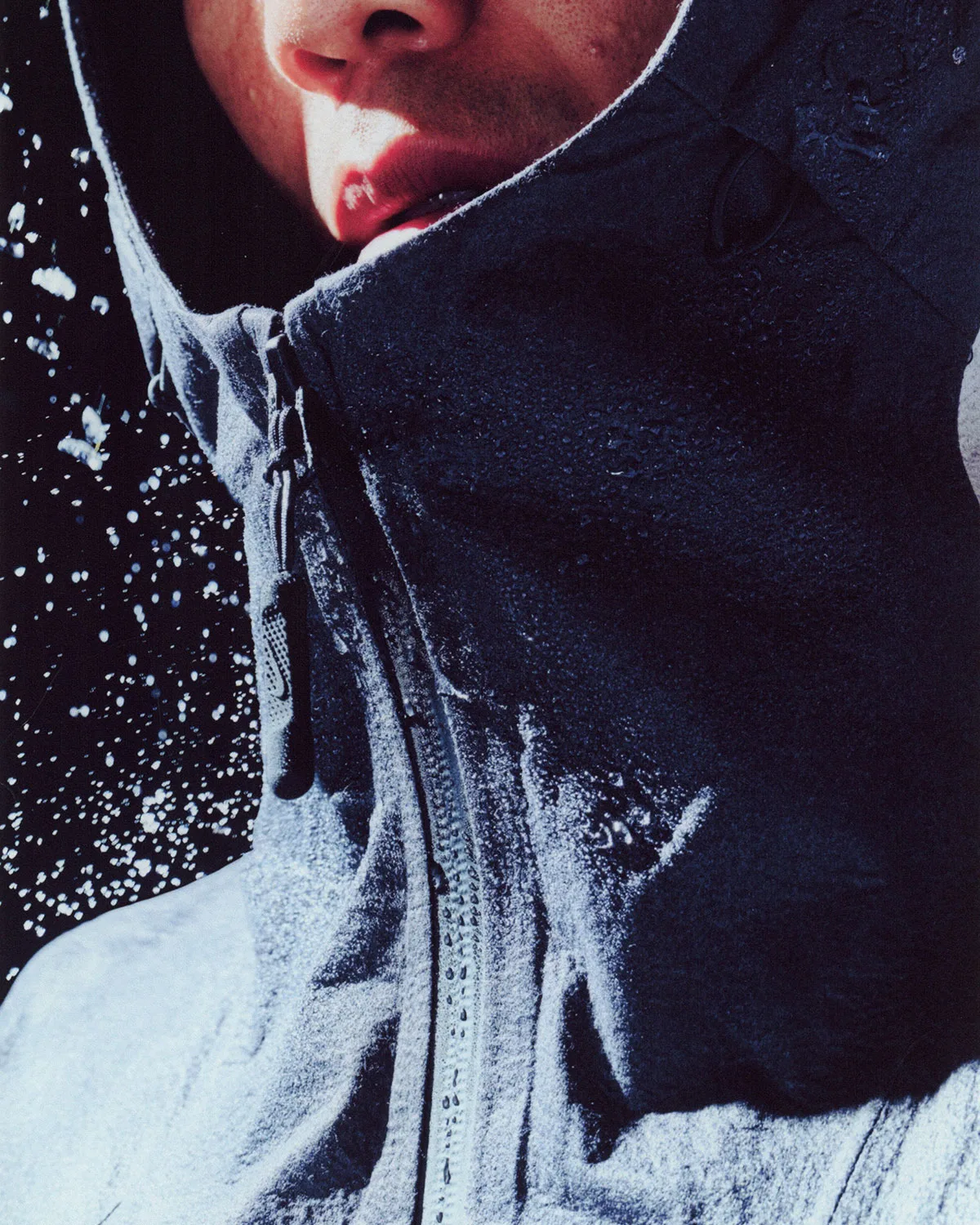 Close-up of frosted grey-blue hood collar and zip pull with water droplets and snow, Boreas and SF3