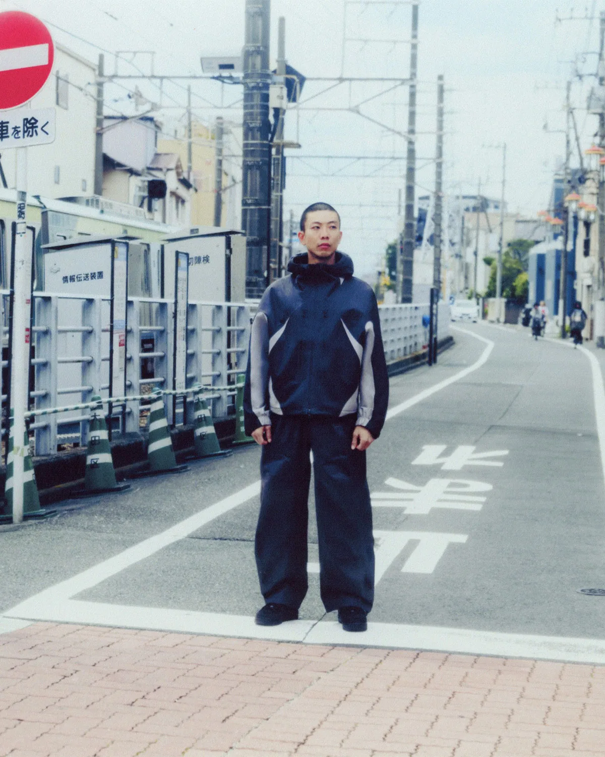 On-foot street shot, navy and grey hooded jacket with wide pants by a Japanese road, Boreas and SF3