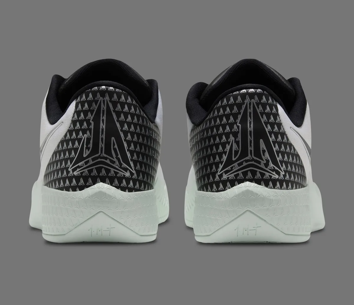 heel view of pair, black heel panels with silver arrow logo and mint green midsoles, White