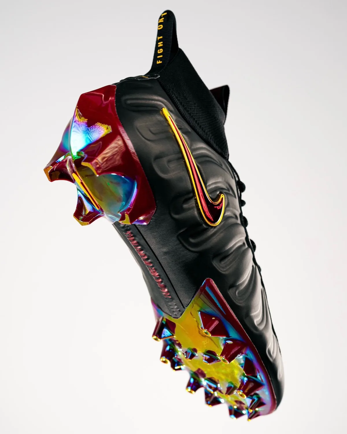 Angled lateral view of black cleat with red-gold swoosh, iridescent maroon studs and "Fight On" pull tab, Pro USC PE