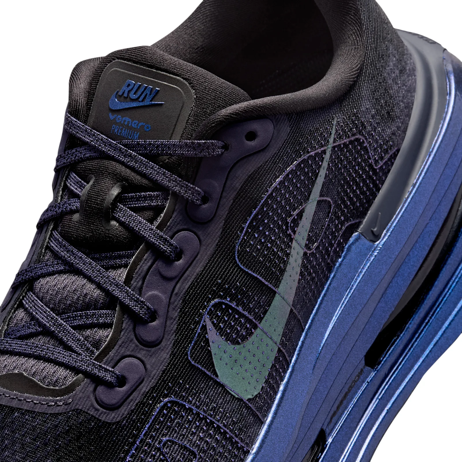 Detail of the lacing and tongue with RUN label, iridescent swoosh and AIR lettering on the black upper, Gridiron