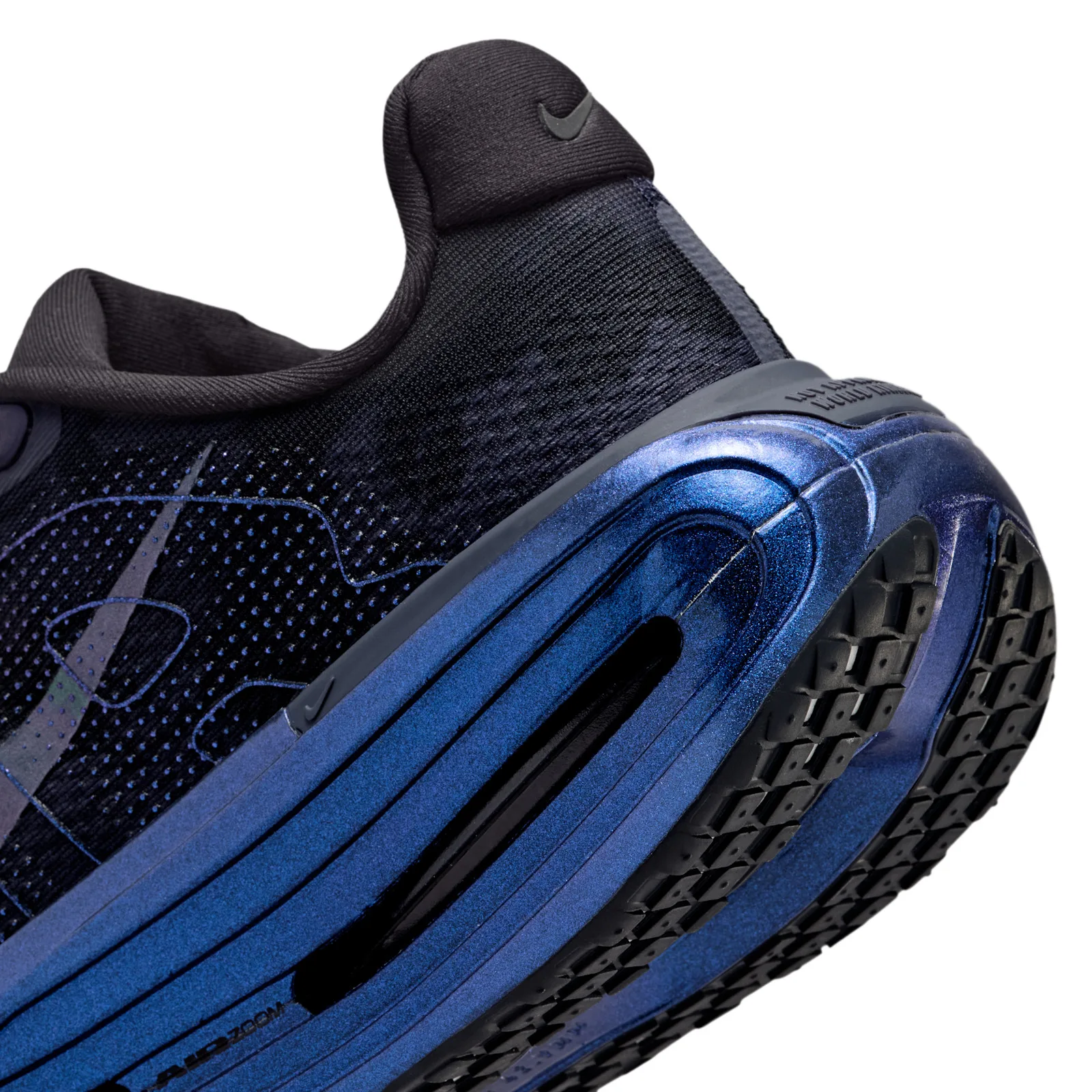 Detail of heel and midsole, iridescent blue foam with a black window and black tread, Gridiron