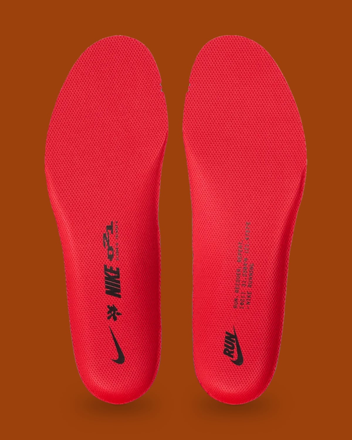 Top-down pair of red insoles with black Nike, RUN logo and small text, Shanghai