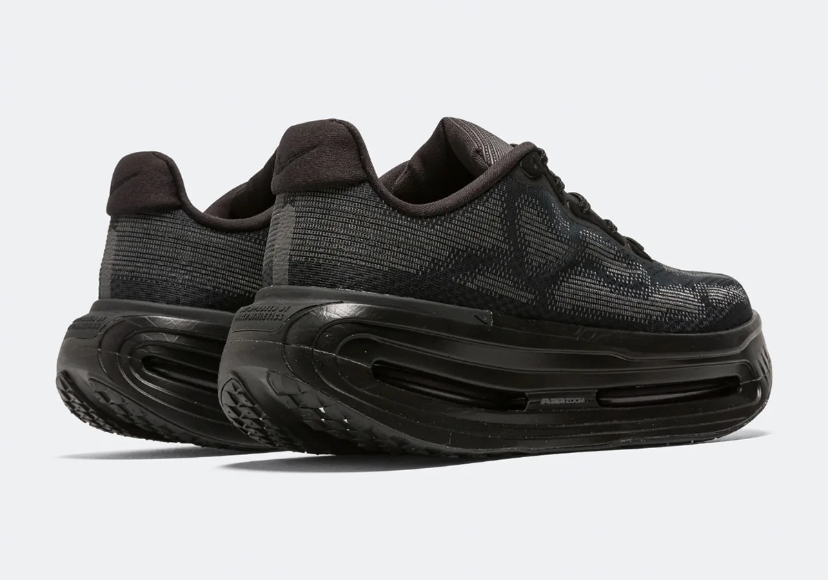 Pair from rear three-quarter angle, black heel tabs, tall midsole and tread visible at heel, Skeleton