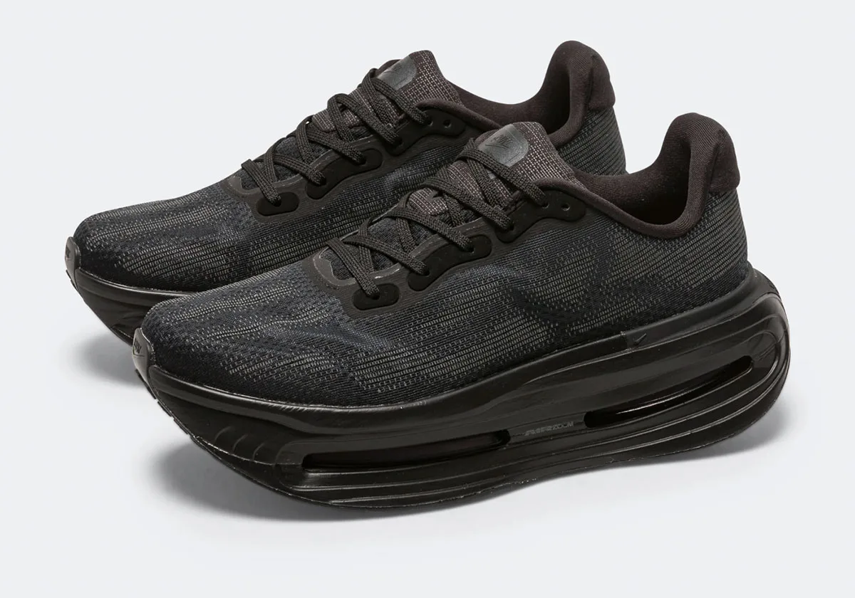 Pair angled front view of black mesh sneakers with thick black midsoles and visible air units, Skeleton