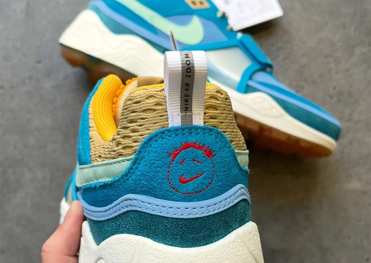 Heel detail in hand: teal suede with red smiley logo and Nike Air Zoom, Nike Zoom Field Jaxx x Travis Scott “Blue” Sample