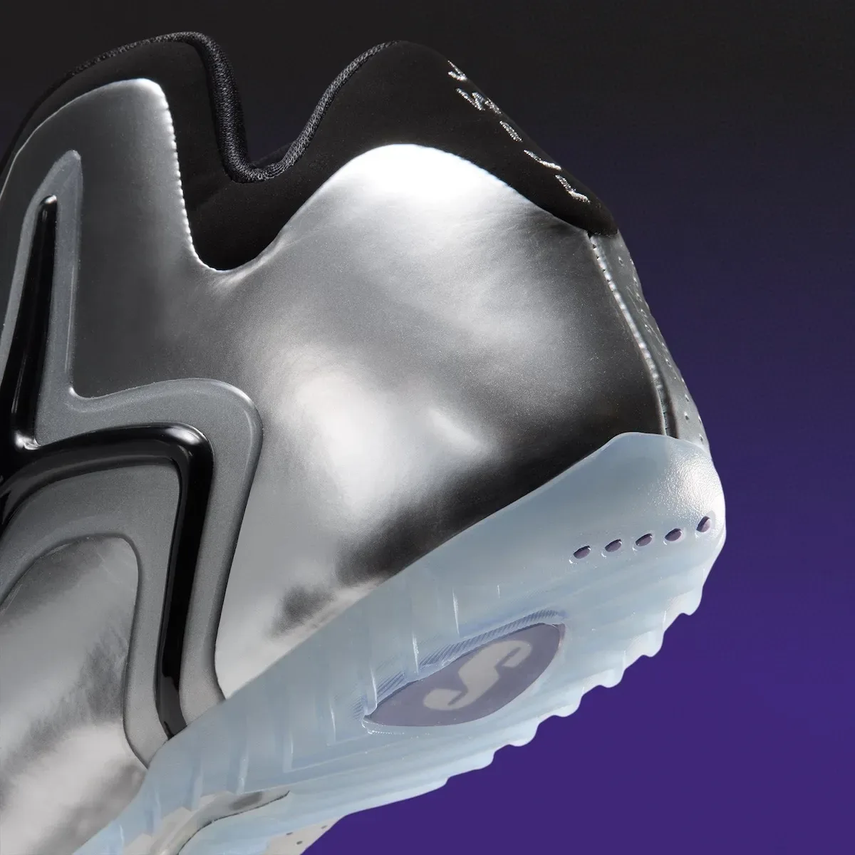 Detail of silver heel and icy sole with purple S logo on purple backdrop, Platinum