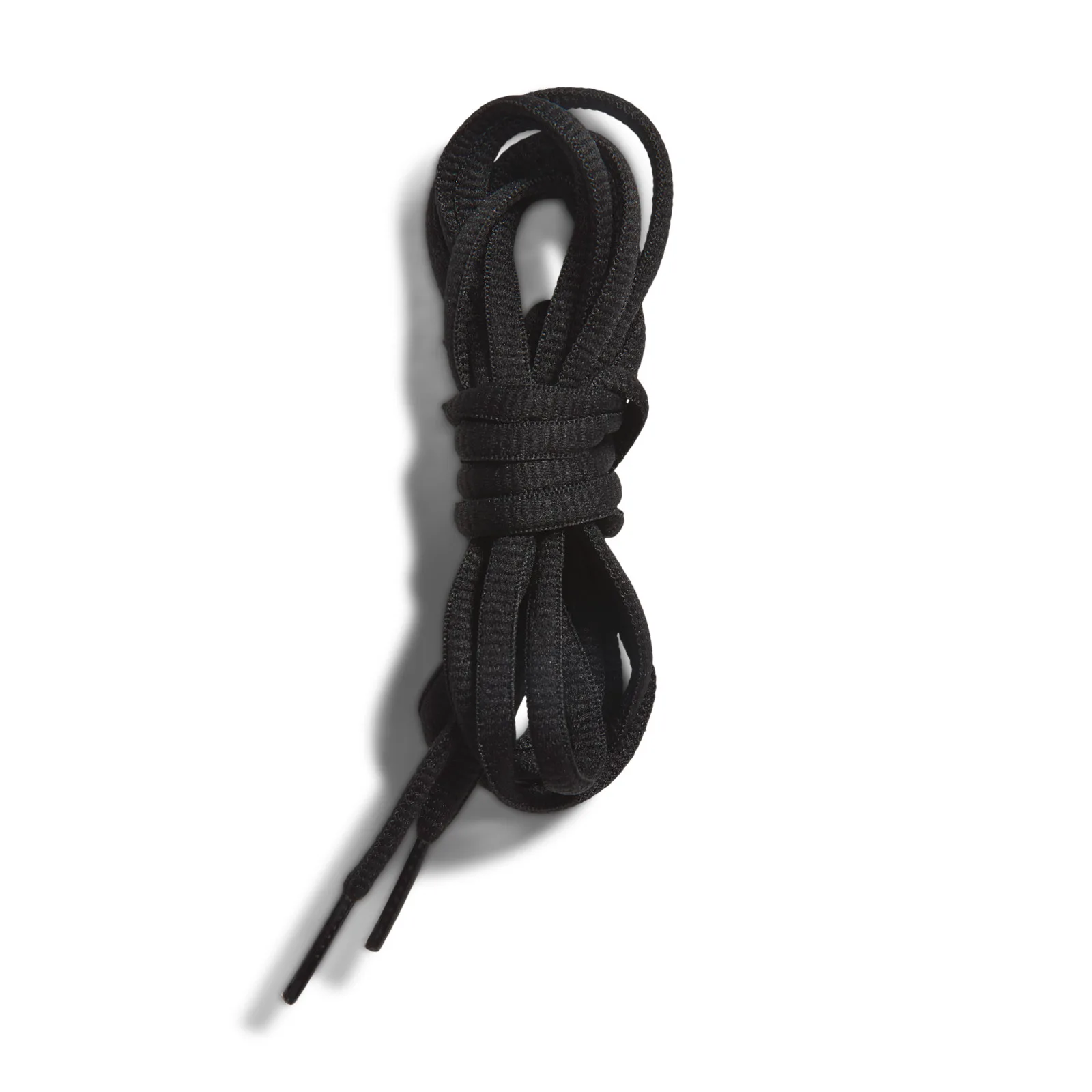 Detail of bundled spare black shoelaces on a white background, Black/Pink