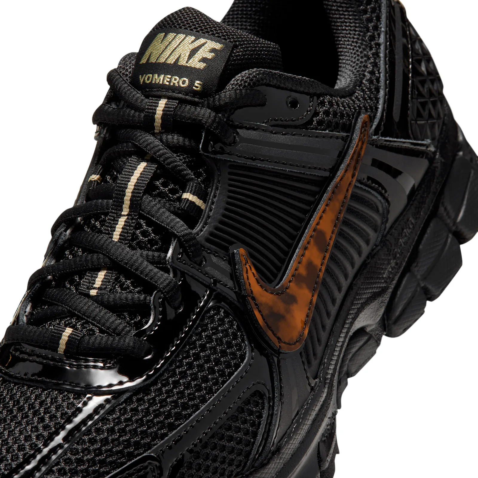 Detail of lacing area, gold NIKE VOMERO 5 tongue label, cream lace markers, amber swoosh, Tortoise Shell