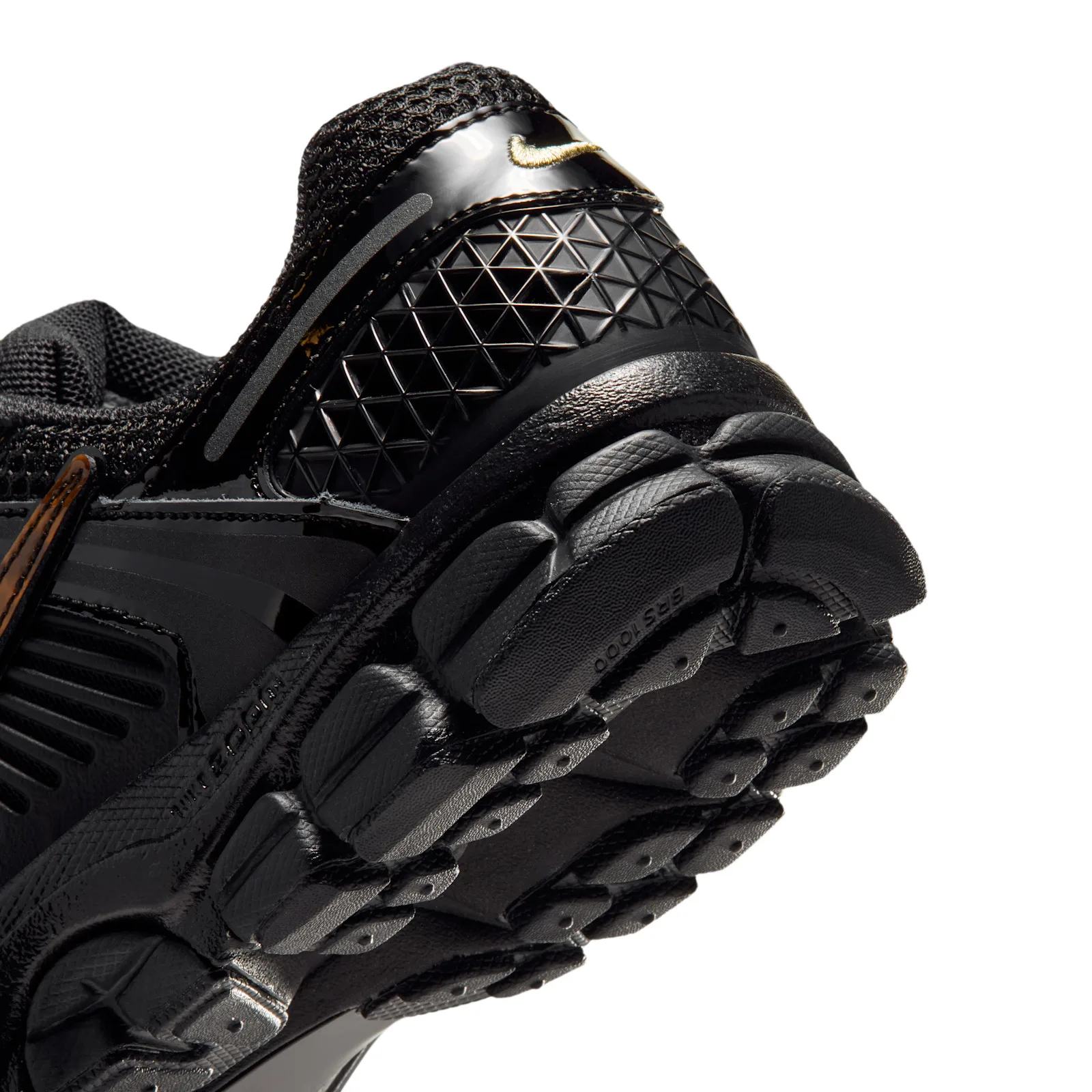Detail of heel and midsole, black triangle-textured heel with small gold swoosh, Tortoise Shell