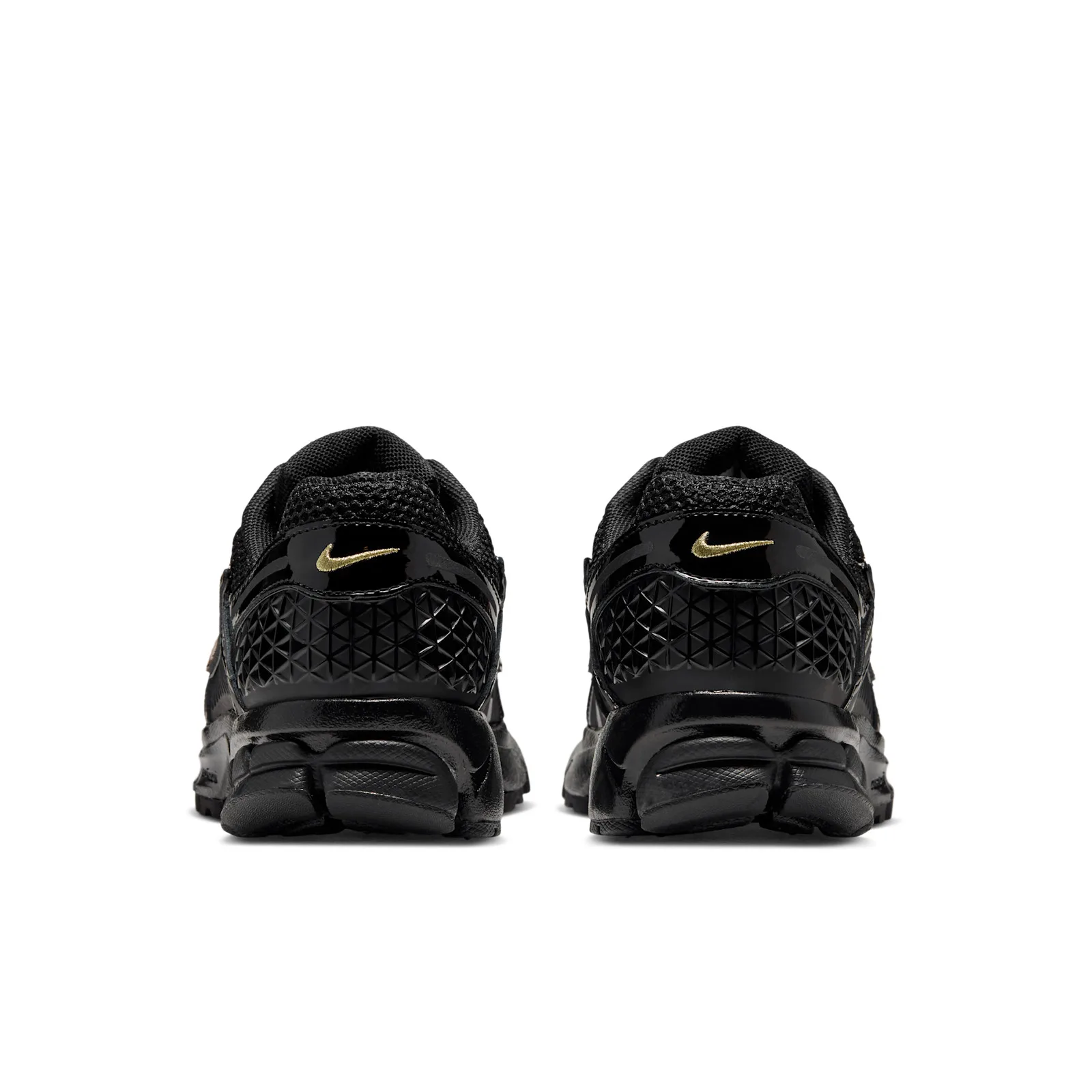 Heel view of pair, gold swoosh on black heel tabs above triangle-textured panels, Tortoise Shell