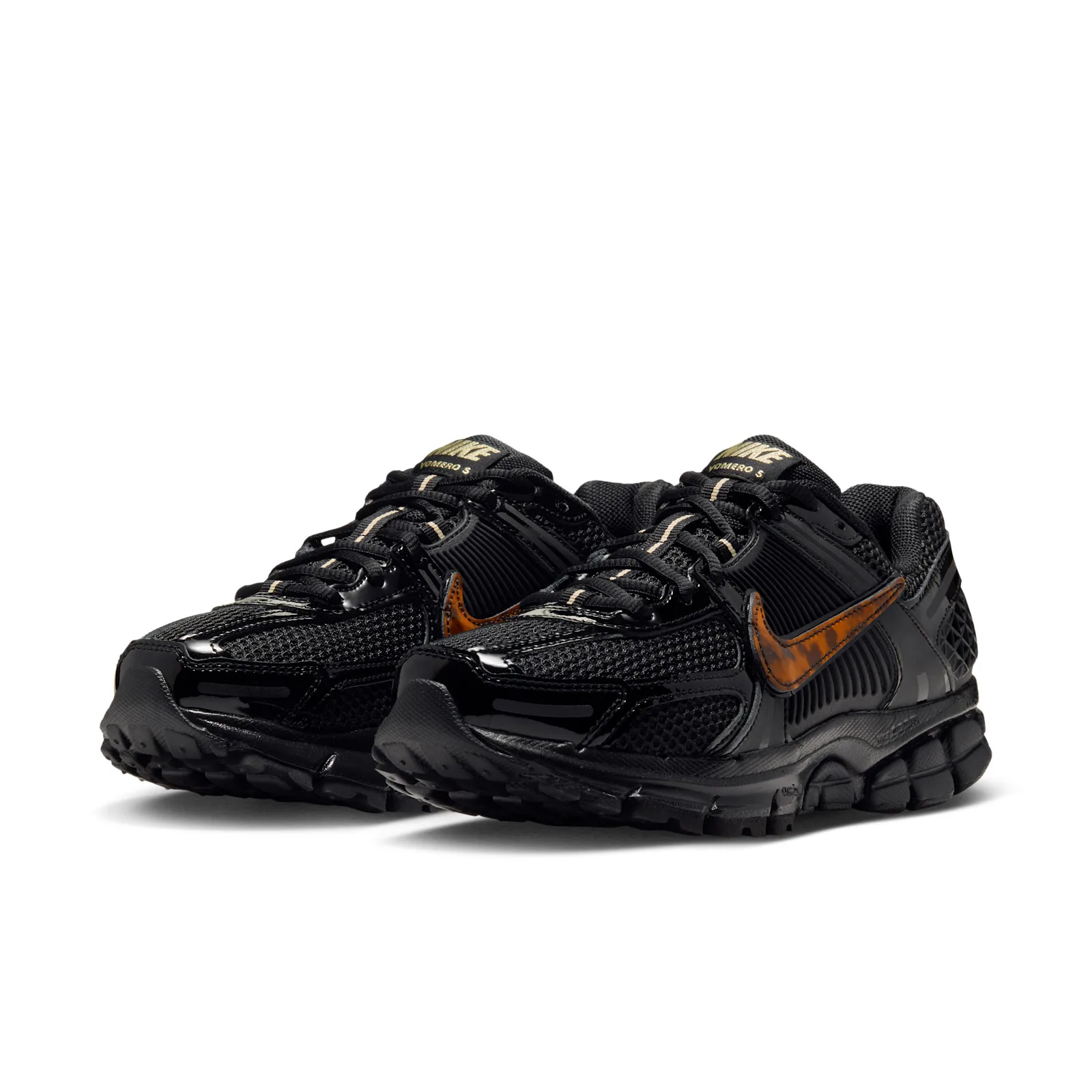 Pair from the front three-quarter, glossy black toe caps and gold tongue labels, Tortoise Shell