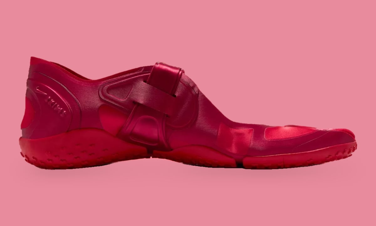 Medial side view, red satin upper with crossing strap and nubbed red sole, University Red