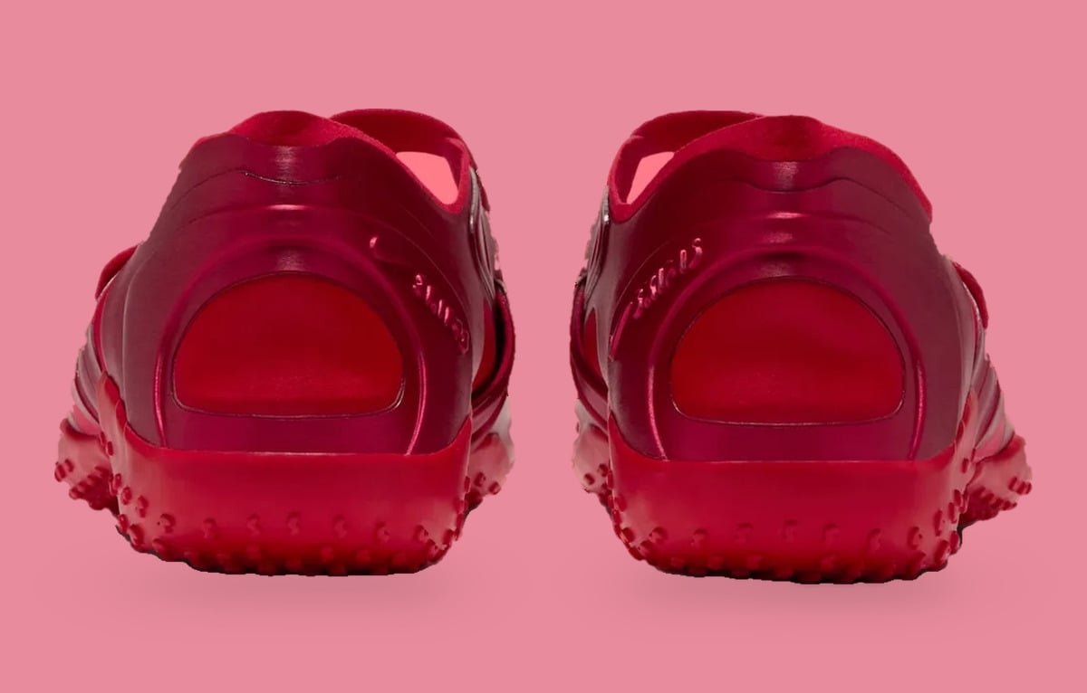 Heel view of pair, red satin heel panels with red nubbed outsoles on pink, University Red