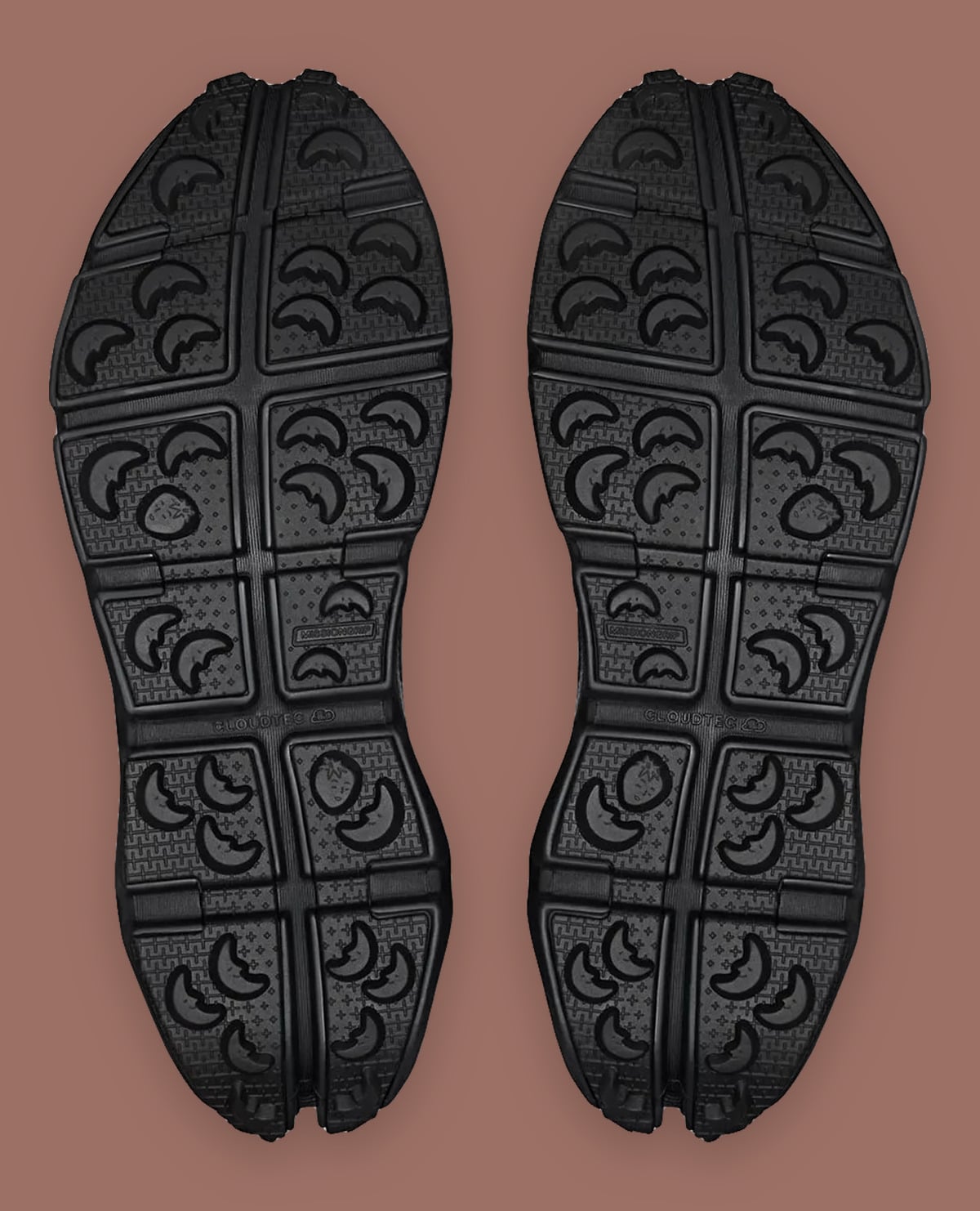 Outsole view of black pair with moon-shaped lugs, Cloudtec text and strawberry motifs, Cloud Low Waterproof