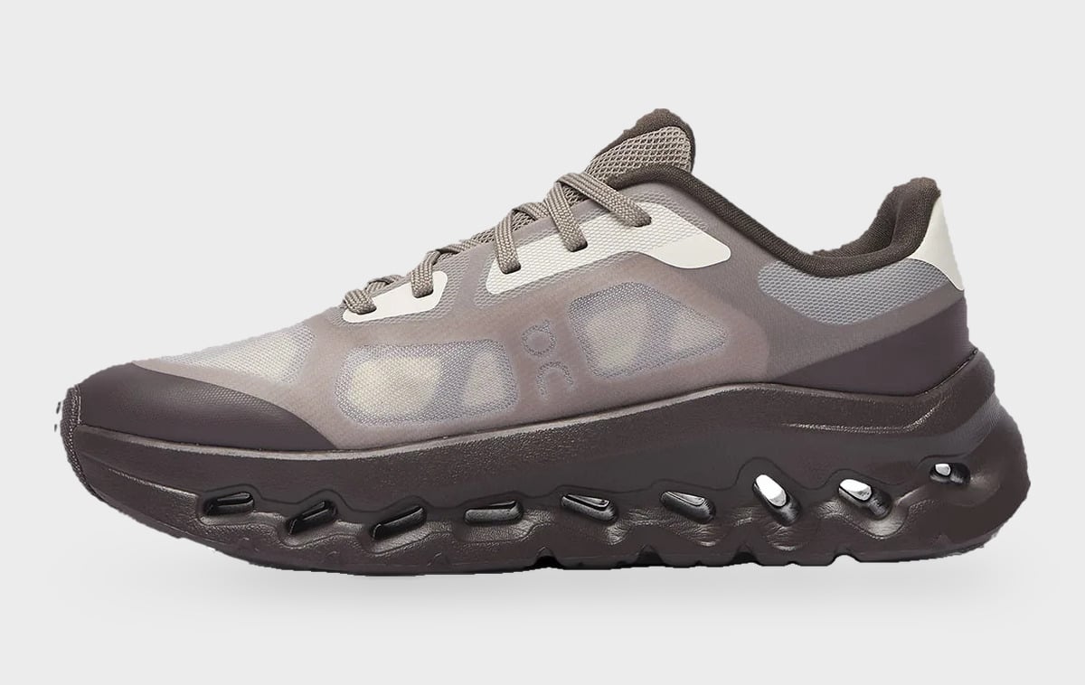 Medial view, brown translucent mesh upper, dark chunky midsole with oval cutouts, Burna Boy Collection