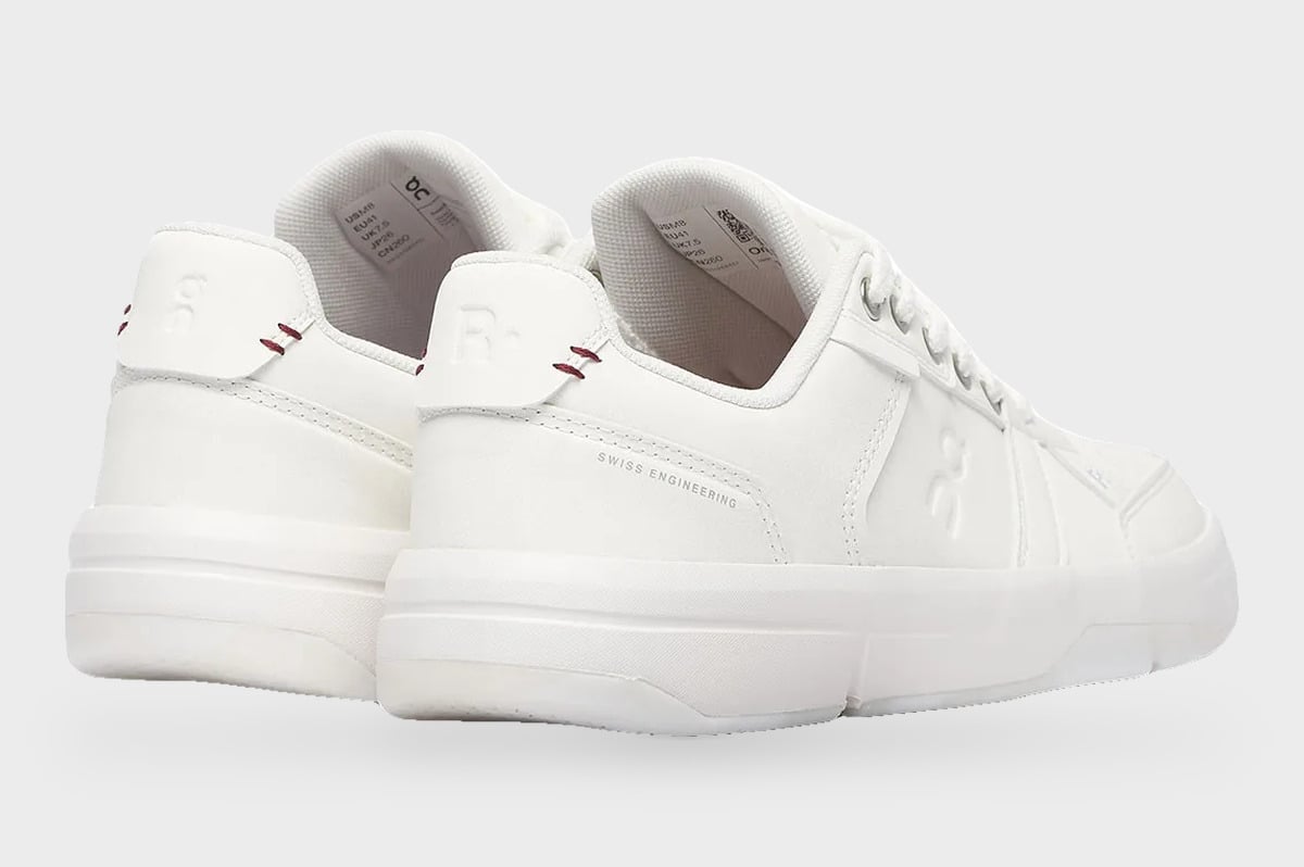 Heel and lateral pair, all-white sneakers with red stitching and fuzzy laces, Burna Boy Collection