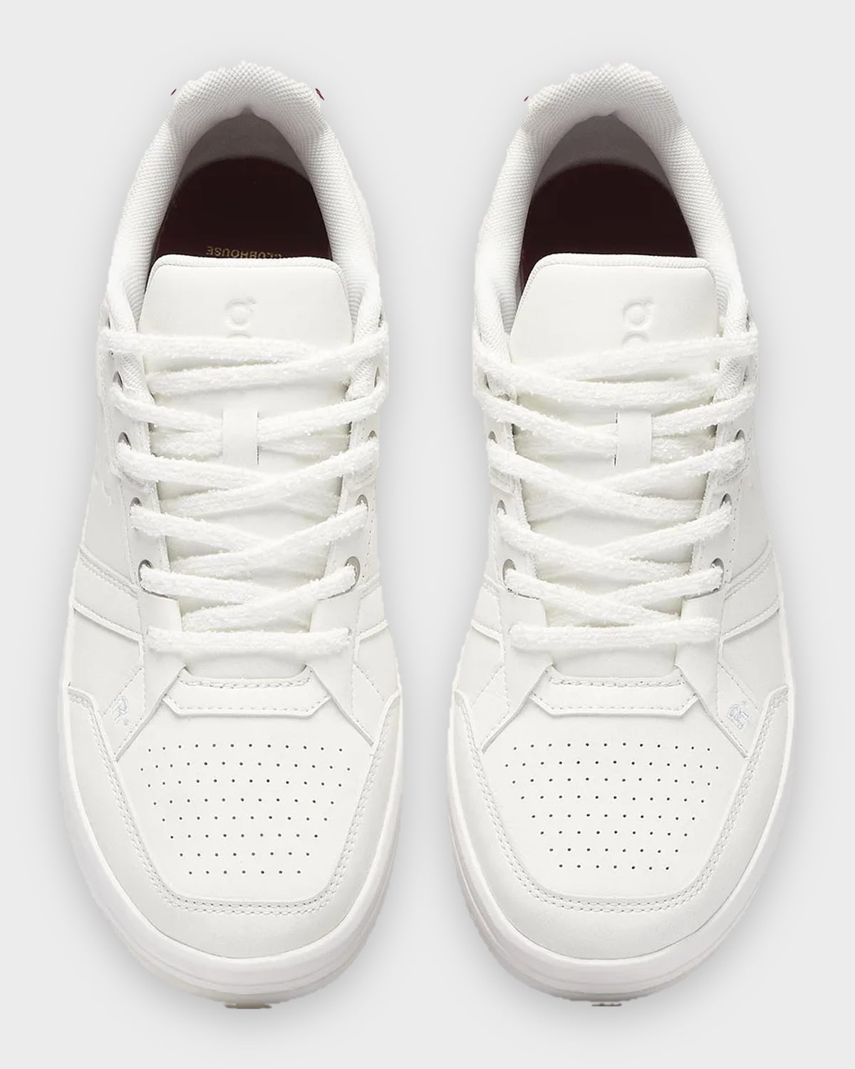 Top-down pair, all-white sneakers with fuzzy white laces and perforated toe boxes, Burna Boy Collection