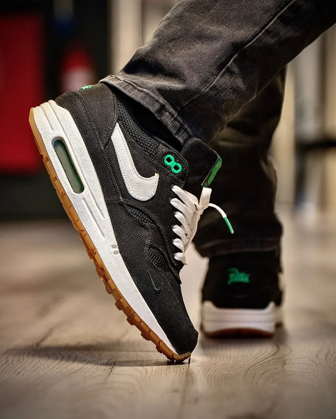 on-foot toe-down lateral view, green 08 tab, second shoe's Patta text visible behind, Lucky Green