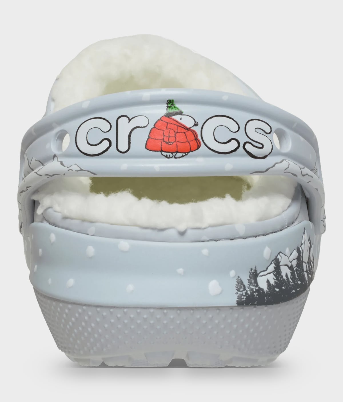 Heel view of grey clog with crocs strap lettering, red puffer figure, green hat, pines and snow dots, Classic Lined Clog